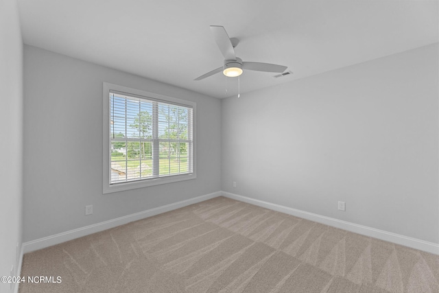 unfurnished room featuring ceiling fan and light carpet