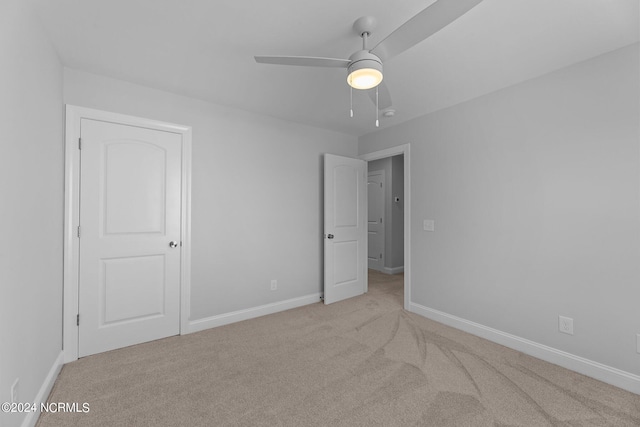 unfurnished bedroom with ceiling fan and light carpet