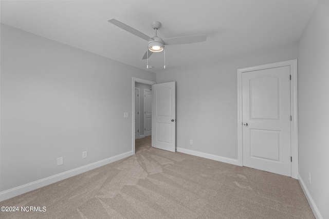 unfurnished bedroom featuring ceiling fan and light carpet