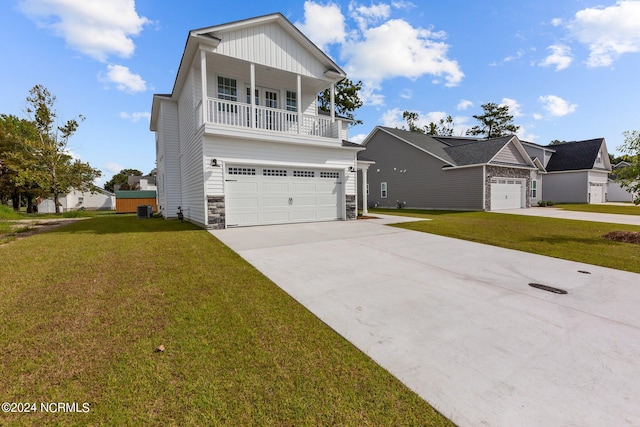 front facade with a garage, a front yard, and a porch