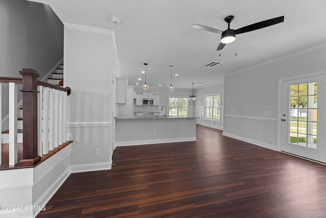 unfurnished living room with ceiling fan, dark hardwood / wood-style floors, crown molding, and sink