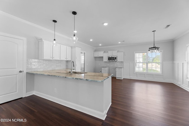 kitchen featuring dark wood-type flooring, kitchen peninsula, sink, and white cabinetry