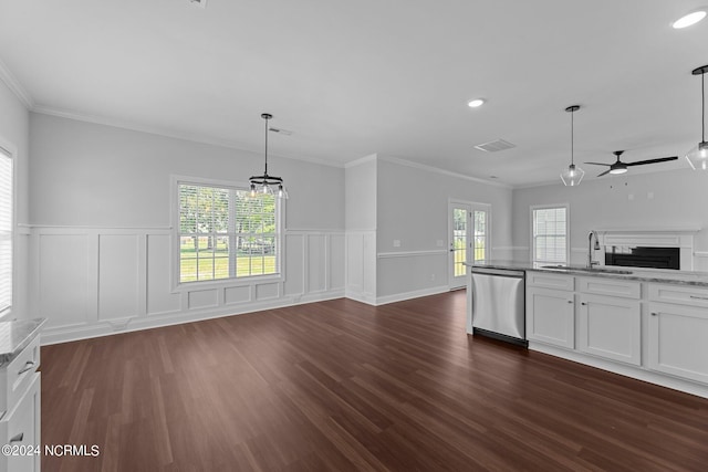 unfurnished living room featuring a healthy amount of sunlight, ceiling fan, dark hardwood / wood-style flooring, and sink