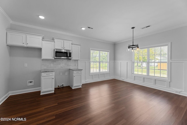 kitchen with dark wood-type flooring, white cabinets, and a wealth of natural light