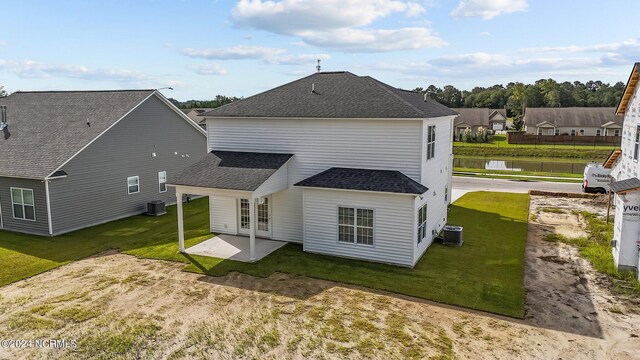 rear view of house with a yard, french doors, a patio, and central air condition unit