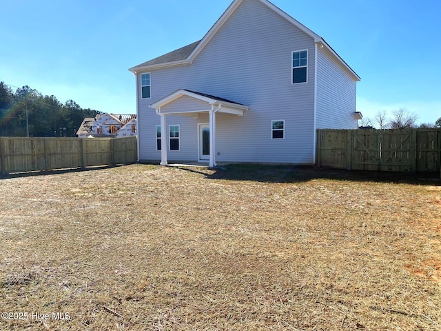 back of house featuring a fenced backyard