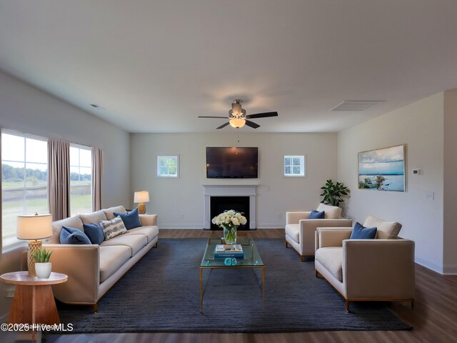 unfurnished living room with ceiling fan and dark hardwood / wood-style flooring