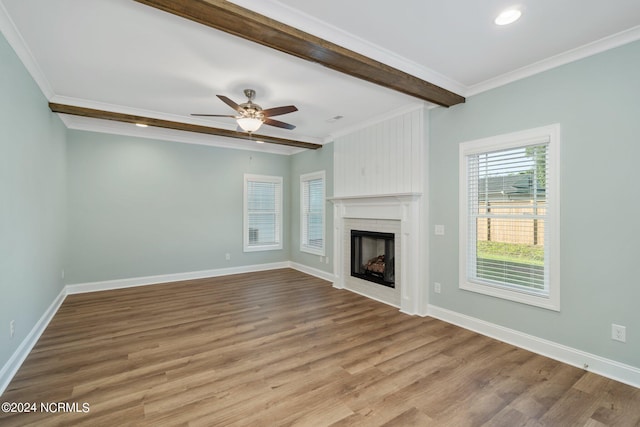 unfurnished living room featuring crown molding, ceiling fan, beamed ceiling, and wood-type flooring