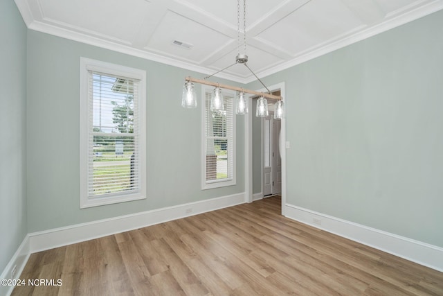 spare room featuring light wood-type flooring, coffered ceiling, a healthy amount of sunlight, and an inviting chandelier