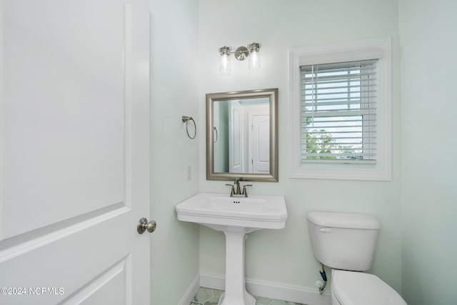 bathroom with toilet and tile patterned floors