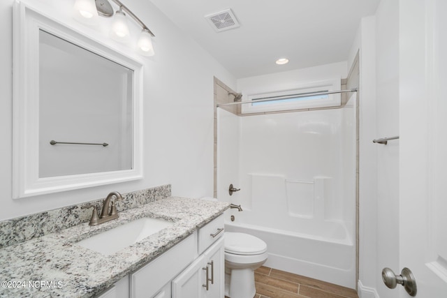 full bathroom featuring vanity, toilet, hardwood / wood-style floors, and bathing tub / shower combination