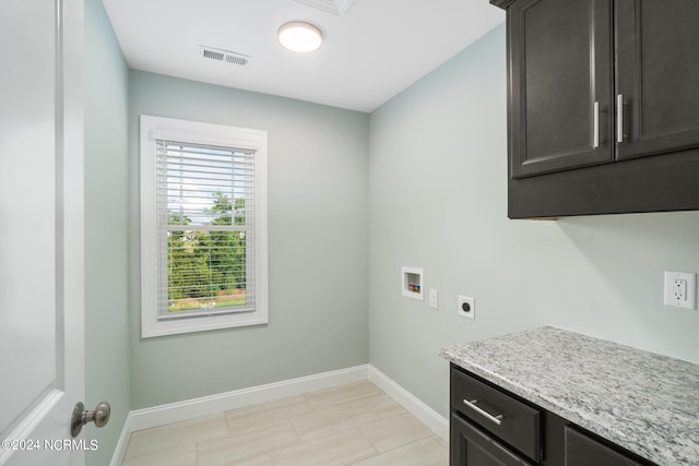 laundry area with hookup for a washing machine, hookup for an electric dryer, cabinets, and a healthy amount of sunlight