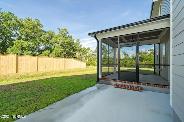 view of yard featuring a patio and a sunroom