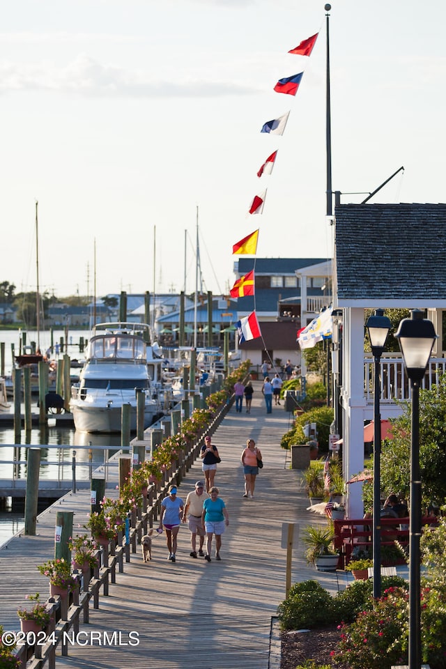 view of community featuring a water view and a dock