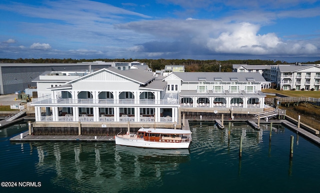 rear view of house with a balcony and a water view