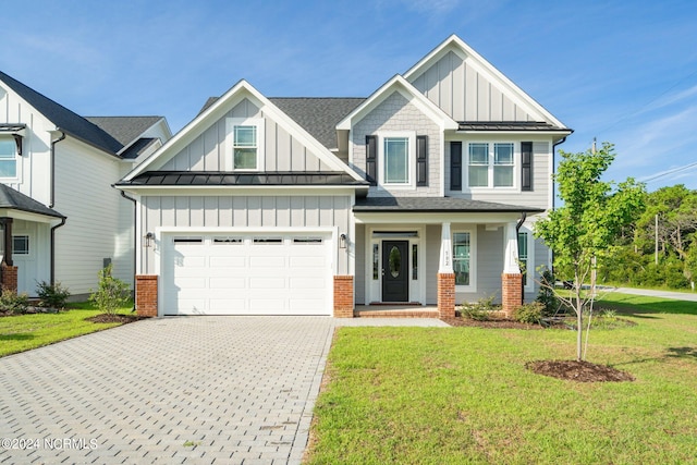 view of front facade with a garage, a front yard, and a porch