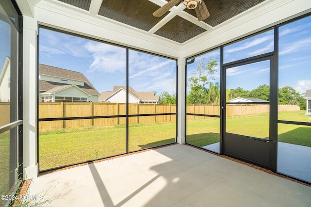 unfurnished sunroom featuring ceiling fan