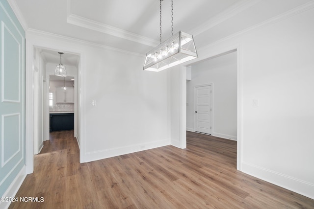 unfurnished dining area with hardwood / wood-style flooring and ornamental molding