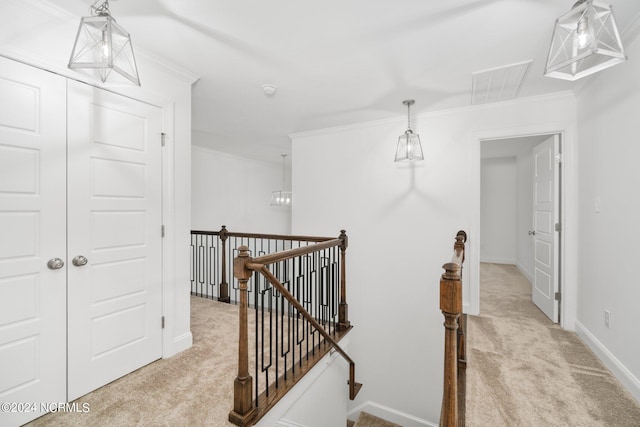 hallway with light carpet and ornamental molding