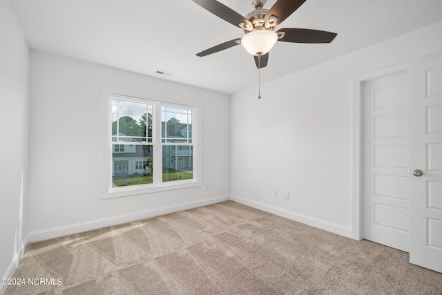 unfurnished room featuring light carpet and ceiling fan