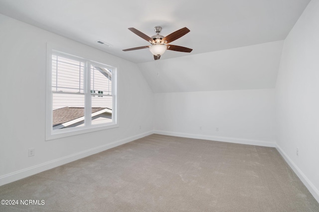 bonus room featuring lofted ceiling, light colored carpet, and ceiling fan