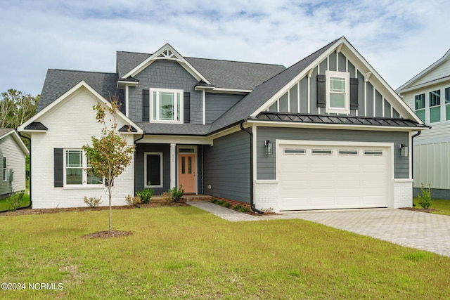 view of front of house with a garage, a front lawn, decorative driveway, and brick siding