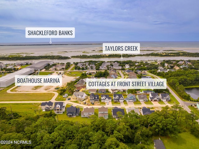 drone / aerial view featuring a water view and a residential view