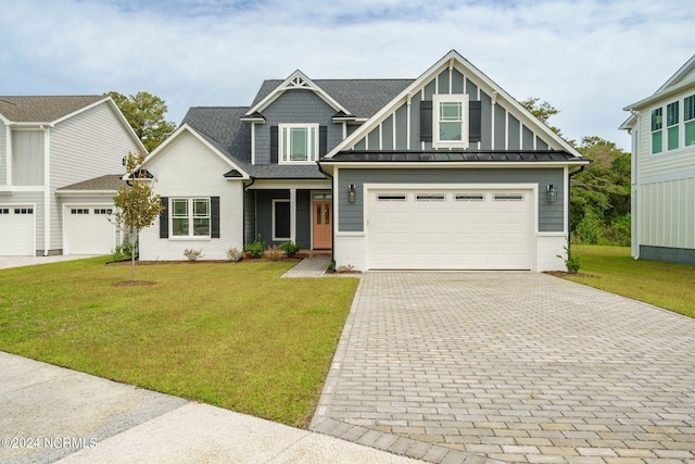 view of front of home with a garage and a front lawn