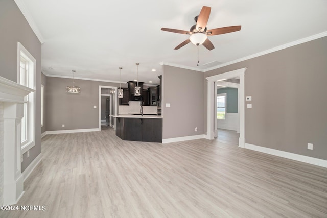 unfurnished living room with ceiling fan, light hardwood / wood-style floors, crown molding, and sink