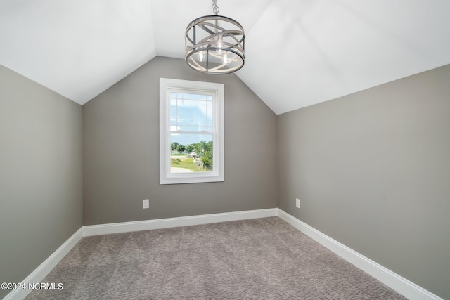 additional living space featuring carpet floors, lofted ceiling, and a chandelier