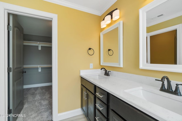 bathroom with crown molding and double vanity