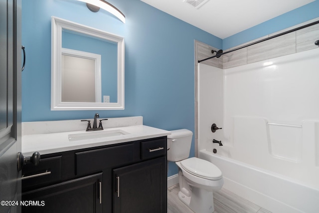 bathroom with visible vents, shower / tub combination, vanity, and toilet