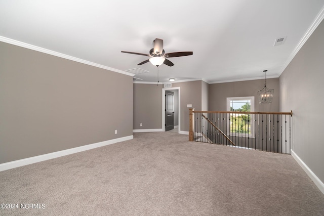 empty room with light carpet, ceiling fan with notable chandelier, and crown molding