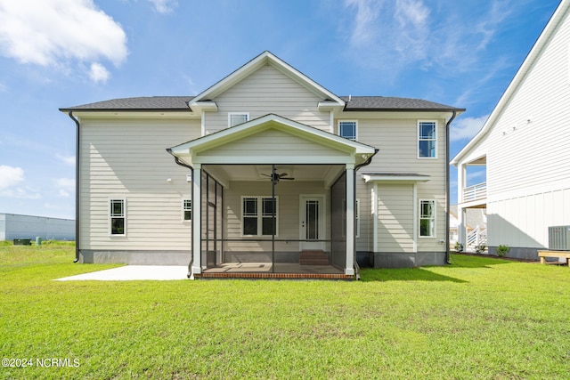 back of house featuring a lawn and ceiling fan