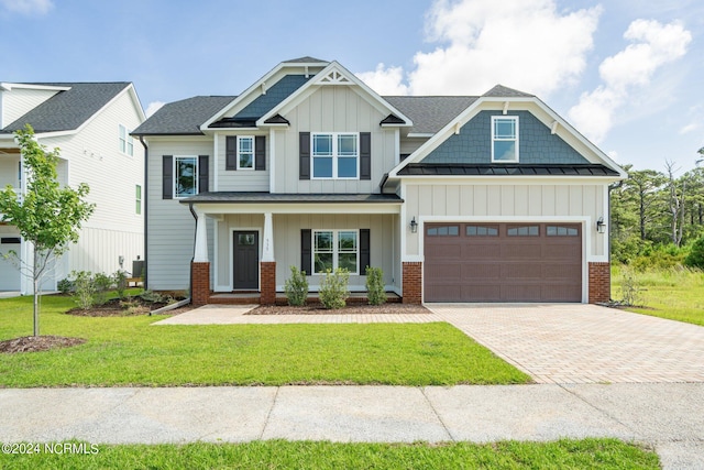 craftsman house featuring a garage, decorative driveway, brick siding, and board and batten siding