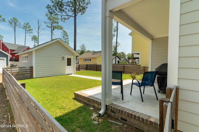 view of yard with an outdoor structure and a patio