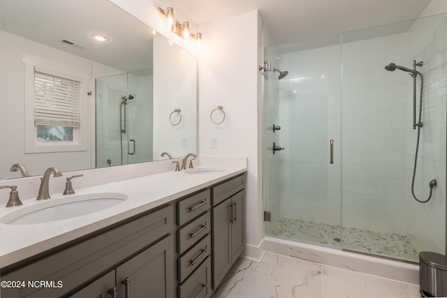 bathroom with vanity and a shower with shower door