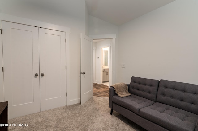 carpeted living room featuring vaulted ceiling