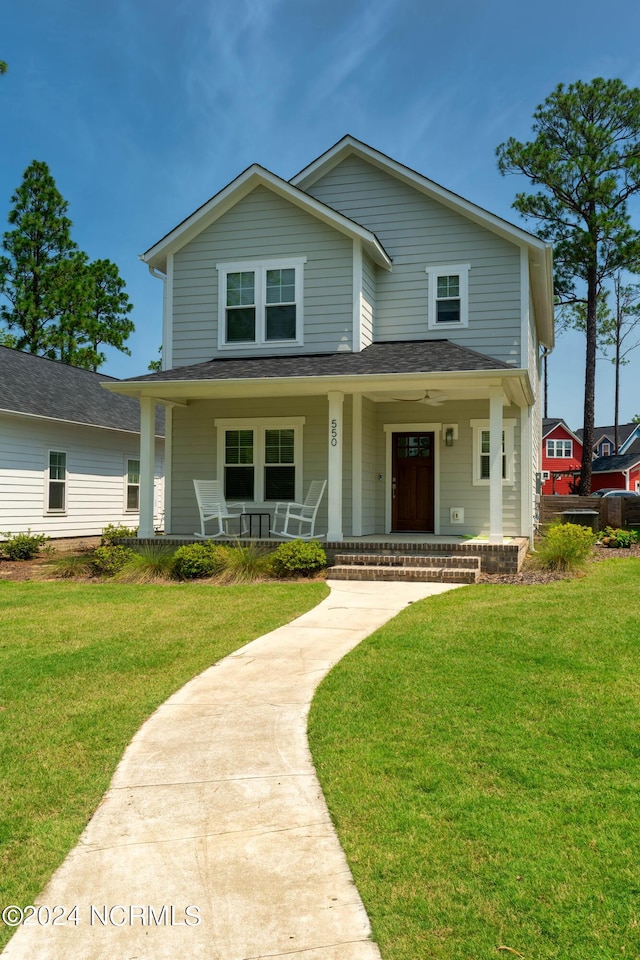 view of front of house with covered porch and a front lawn