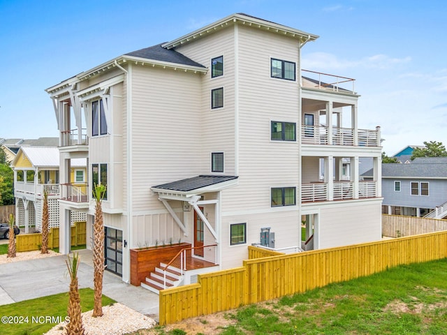 exterior space featuring a garage and a balcony