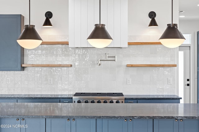 kitchen with blue cabinetry and tasteful backsplash