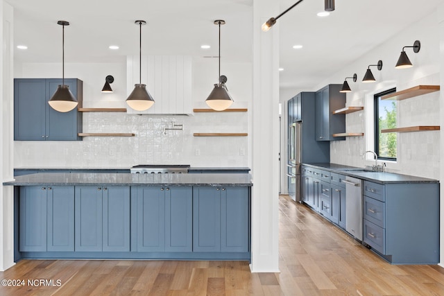 kitchen with light hardwood / wood-style floors, tasteful backsplash, and blue cabinets