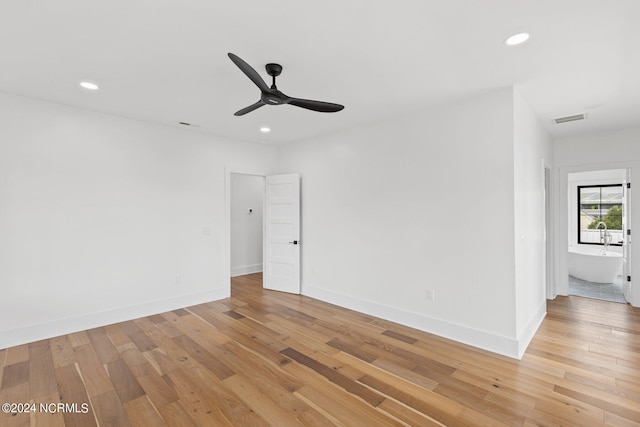 unfurnished room with ceiling fan and light wood-type flooring