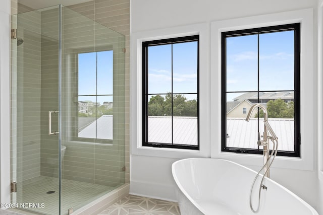 bathroom featuring independent shower and bath and tile patterned flooring