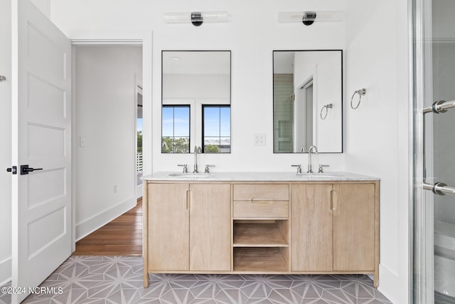 bathroom with hardwood / wood-style floors and dual bowl vanity