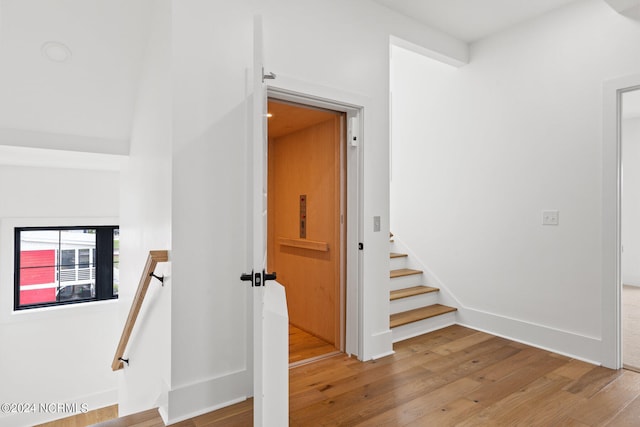 stairs featuring light wood-type flooring