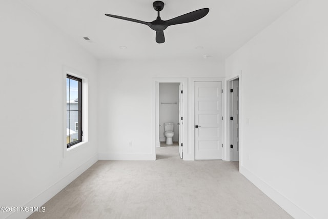 unfurnished bedroom with carpet, connected bathroom, and ceiling fan