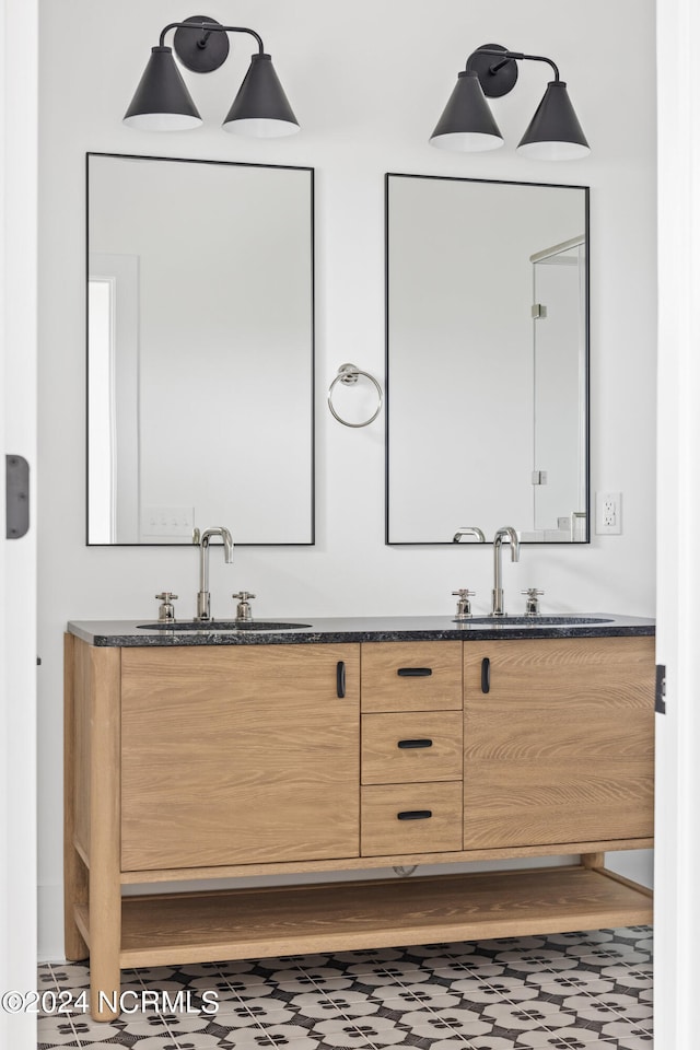 bathroom with double vanity and tile patterned floors