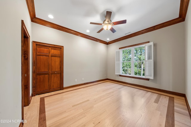 unfurnished bedroom with crown molding, light hardwood / wood-style floors, and ceiling fan