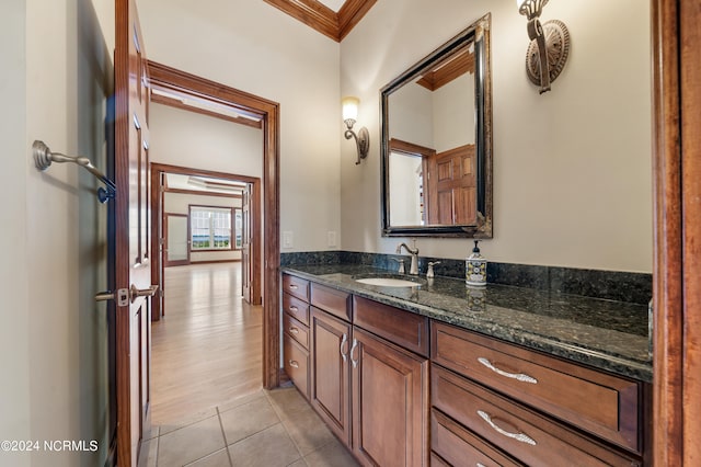 bathroom featuring vanity, ornamental molding, and wood-type flooring